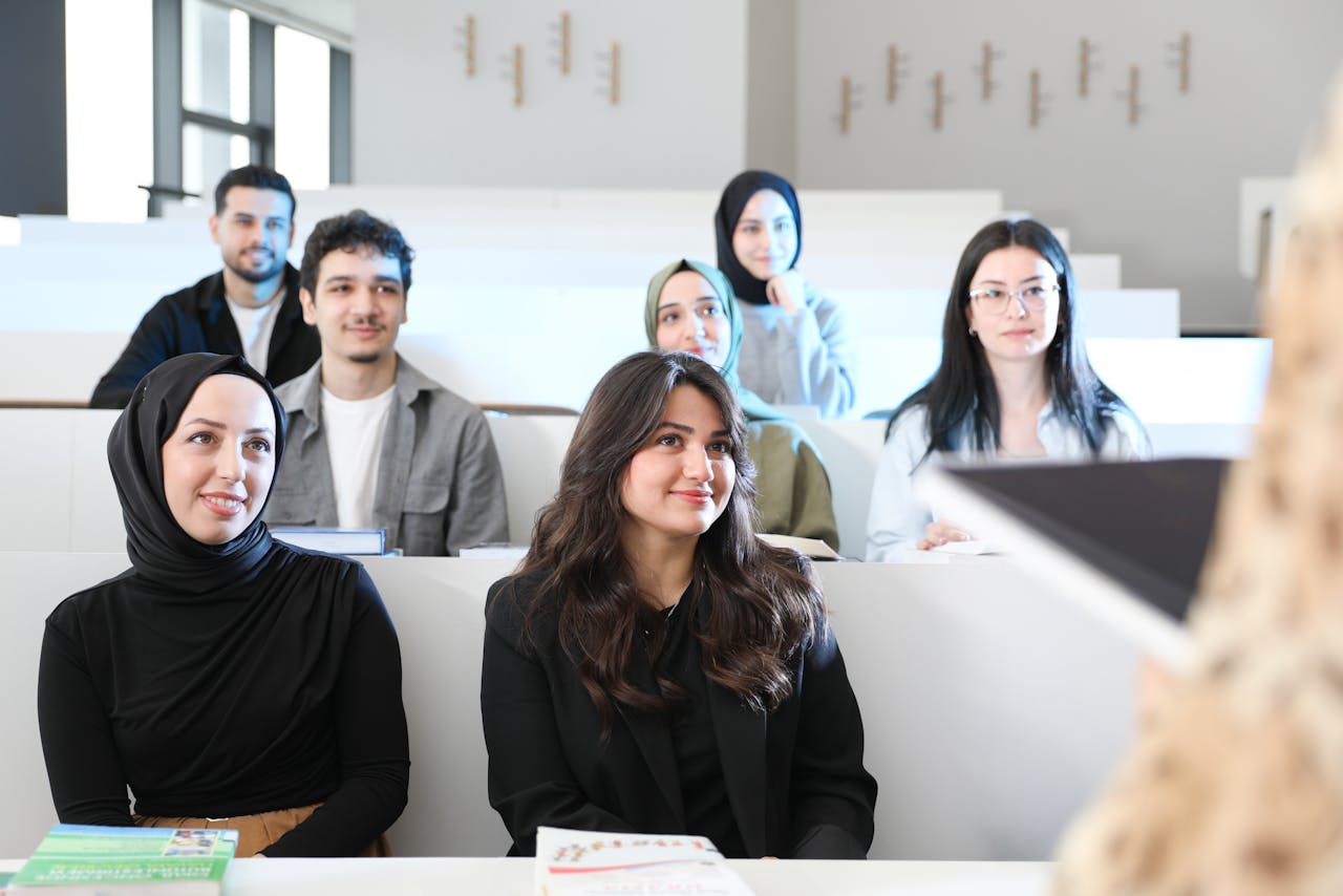 Diverse group of students attentively listening in a university lecture hall.